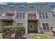 Rear exterior of townhome featuring multiple balconies and vinyl siding at 5824 Cameo Glass Way, Raleigh, NC 27612