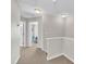 Hallway with carpet flooring, access to multiple rooms, and white doors at 5824 Cameo Glass Way, Raleigh, NC 27612