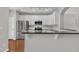 Modern kitchen with white cabinets, stainless steel appliances, and granite countertops at 5824 Cameo Glass Way, Raleigh, NC 27612