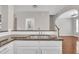 Kitchen sink area showing granite countertops and white subway tile backsplash at 5824 Cameo Glass Way, Raleigh, NC 27612