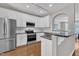 Modern kitchen with white cabinets, stainless steel appliances, and granite countertops at 5824 Cameo Glass Way, Raleigh, NC 27612