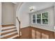 Open-plan room with hardwood floors and ample natural light with easy access to stairs at 5824 Cameo Glass Way, Raleigh, NC 27612