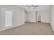 Spacious living room with carpet flooring, ceiling fan, and access to the patio at 5824 Cameo Glass Way, Raleigh, NC 27612