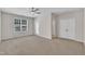 Spacious living room with carpet flooring, ceiling fan, and double-door closet at 5824 Cameo Glass Way, Raleigh, NC 27612