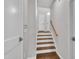 Bright stairway with wooden steps and handrail leading to the upper level of the home at 5824 Cameo Glass Way, Raleigh, NC 27612