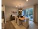 Inviting dining room with stylish lighting and access to an outdoor patio at 5900 Dunzo Dr, Raleigh, NC 27617
