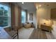 Cozy bedroom nook with comfy chair by large windows offering peaceful views and natural light at 5900 Dunzo Dr, Raleigh, NC 27617