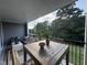 Relaxing outdoor patio with dining area overlooking lush greenery and scenic views at 5900 Dunzo Dr, Raleigh, NC 27617