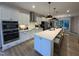 Modern kitchen features white cabinets, stainless steel appliances, and large island with pendant lighting at 5902 Dunzo Dr, Raleigh, NC 27617