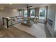 Open-concept living room with a cozy sectional, fireplace, and plenty of natural light at 5902 Dunzo Dr, Raleigh, NC 27617