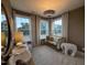 Bright Bedroom featuring a crib, changing table, large windows, and neutral decor for a cozy atmosphere at 5904 Dunzo Dr, Raleigh, NC 27617