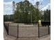 Fenced dog park area with trees in the background, providing a safe and fun place for pets at 5904 Dunzo Dr, Raleigh, NC 27617