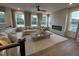 Bright living room features a fireplace, large windows, and a comfortable sectional sofa at 5904 Dunzo Dr, Raleigh, NC 27617