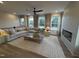 Bright living room features a fireplace, large windows, and a comfortable sectional sofa at 5904 Dunzo Dr, Raleigh, NC 27617