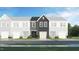 New townhome with gray siding, stone accents, and a two-car garage in a suburban neighborhood at 6015 Grey Colt Way, Durham, NC 27703