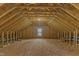 Unfinished attic space displaying rafters and plywood floor at 6332 Mountain Oaks Way, Wake Forest, NC 27587