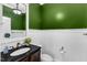 Charming half bathroom featuring a black countertop and white wainscoting at 6332 Mountain Oaks Way, Wake Forest, NC 27587