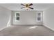 A bedroom with carpet and two windows offers natural light at 6332 Mountain Oaks Way, Wake Forest, NC 27587