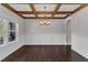 Open dining area showcasing dark hardwood floors, chandelier, and wainscoting at 6332 Mountain Oaks Way, Wake Forest, NC 27587