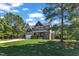 Inviting two-story home with a green lawn, mature trees, and a long driveway on a sunny day at 6332 Mountain Oaks Way, Wake Forest, NC 27587