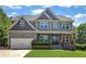 Charming two-story home with a beautifully landscaped front yard and welcoming front porch at 6332 Mountain Oaks Way, Wake Forest, NC 27587