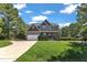 Attractive home featuring a two-car garage, manicured lawn, and traditional design elements at 6332 Mountain Oaks Way, Wake Forest, NC 27587