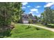 Exterior view of a two-story home with a well-maintained lawn and long driveway at 6332 Mountain Oaks Way, Wake Forest, NC 27587