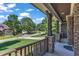 View from the front porch with stone pillars and a serene neighborhood street view at 6332 Mountain Oaks Way, Wake Forest, NC 27587