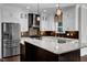 Spacious kitchen featuring stainless steel appliances, white cabinets, and granite countertops at 6332 Mountain Oaks Way, Wake Forest, NC 27587