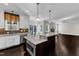 Bright, open kitchen with a large island, stainless steel appliances, and access to the screened porch at 6332 Mountain Oaks Way, Wake Forest, NC 27587