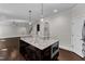 Open-concept kitchen with a large island, pendant lighting, and stainless steel microwave at 6332 Mountain Oaks Way, Wake Forest, NC 27587