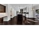 Open-concept kitchen with island, stainless steel appliances, and dark hardwood floors at 6332 Mountain Oaks Way, Wake Forest, NC 27587