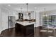 Modern kitchen with island, stainless steel appliances, and hardwood floors at 6332 Mountain Oaks Way, Wake Forest, NC 27587