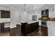 Modern kitchen with granite island, stainless steel appliances, and hardwood floors at 6332 Mountain Oaks Way, Wake Forest, NC 27587