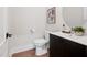 Stylish bathroom with a modern vanity, oval mirror, and hardwood floors offers a clean and elegant design at 703 E Markham Ave, Durham, NC 27701