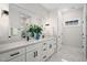 Elegant bathroom featuring dual vanities, modern fixtures, and a large mirror above the countertops at 703 E Markham Ave, Durham, NC 27701