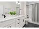 Bathroom featuring double vanity with modern faucets, white cabinetry, and a shower-tub combo at 703 E Markham Ave, Durham, NC 27701