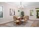 Elegant dining room featuring natural light, a stylish chandelier, and comfortable seating for Gathering gatherings at 703 E Markham Ave, Durham, NC 27701