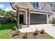 A beautifully landscaped front entrance with a dark stained wood column and a two-car garage at 703 E Markham Ave, Durham, NC 27701