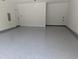 Spacious garage with a durable, speckled floor coating and white walls, offering ample storage and parking space at 703 E Markham Ave, Durham, NC 27701