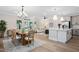 Open-concept living and dining area with modern lighting, wood floors, and a seamless flow for entertaining at 703 E Markham Ave, Durham, NC 27701