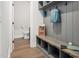 A practical mudroom with a built-in bench, storage shelves, and hooks, offering organization and convenience at 703 E Markham Ave, Durham, NC 27701