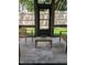 Inviting sunroom features a center table with potted greenery, wooden chairs, and a view of the green backyard at 703 E Markham Ave, Durham, NC 27701