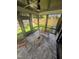 Cozy screened-in porch with tiled flooring and a ceiling fan offers a relaxing space to enjoy the outdoors at 703 E Markham Ave, Durham, NC 27701