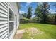 Spacious backyard with a well-maintained lawn, bordered by mature trees and a privacy fence at 709 Woodgreen Dr, Durham, NC 27704