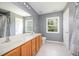 Bright bathroom featuring a double sink vanity and large mirror with great natural light at 709 Woodgreen Dr, Durham, NC 27704