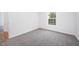 Bright bedroom with plush carpeting and a window offering natural light and outdoors view at 709 Woodgreen Dr, Durham, NC 27704