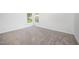 Neutral bedroom with plush carpeting and a bright window with views of the outdoors at 709 Woodgreen Dr, Durham, NC 27704