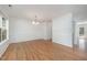 Bright dining area with hardwood floors, white trim, and a modern chandelier at 709 Woodgreen Dr, Durham, NC 27704