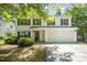 Charming two-story home with white siding, black shutters, and a two-car garage at 709 Woodgreen Dr, Durham, NC 27704